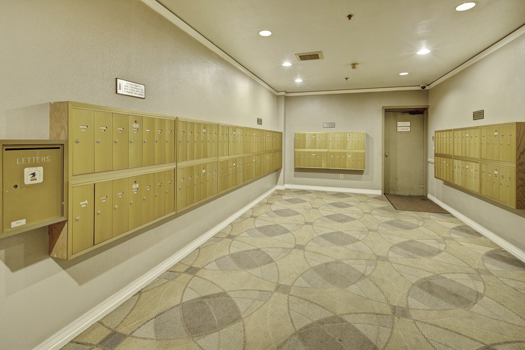 A hallway with a series of lockers on the wall.
