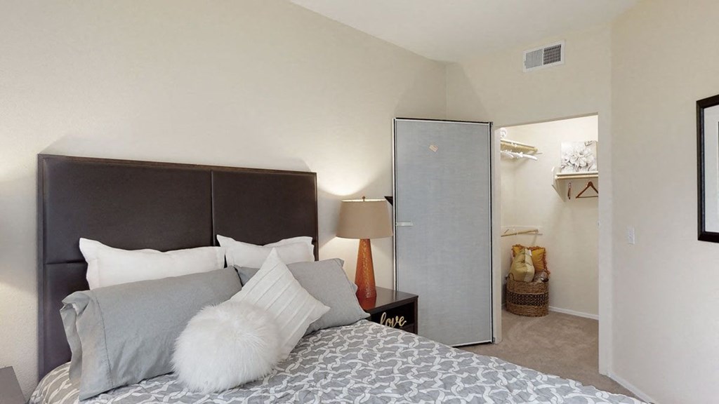 Acclaim Apartments- furnished bedroom with a king-sized bed