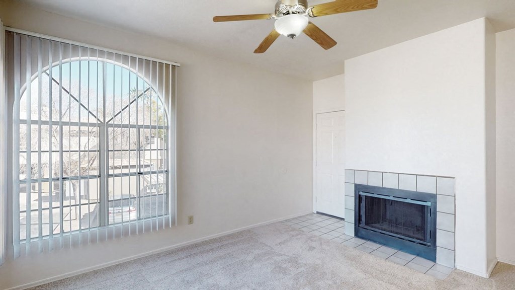 a living room with a fireplace and a large window