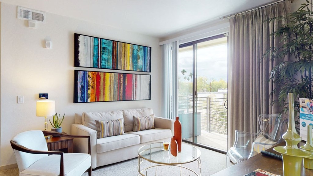a living room with a white couch and a glass coffee table