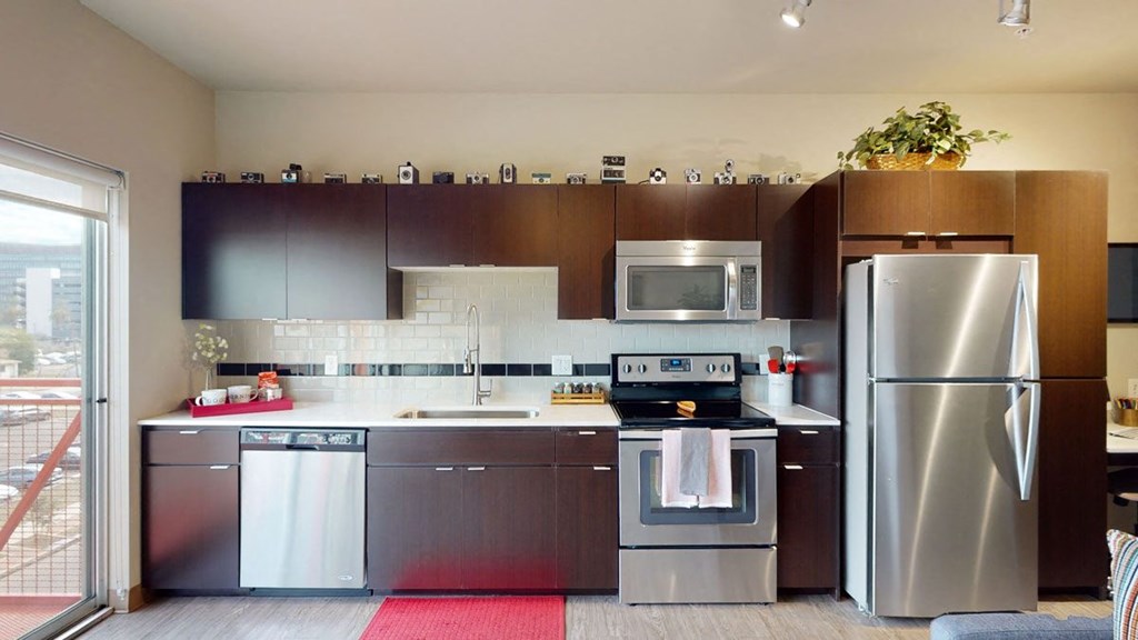 a kitchen with a stove top oven next to a refrigerator