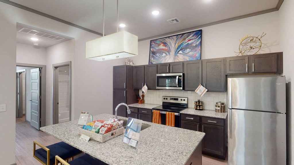 a kitchen with stainless steel appliances and granite counter tops