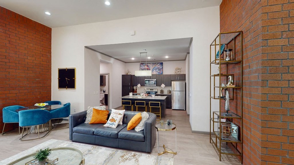a living room with a couch and a kitchen in the background