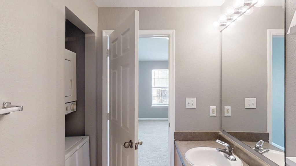 A bathroom with a sink and a mirror