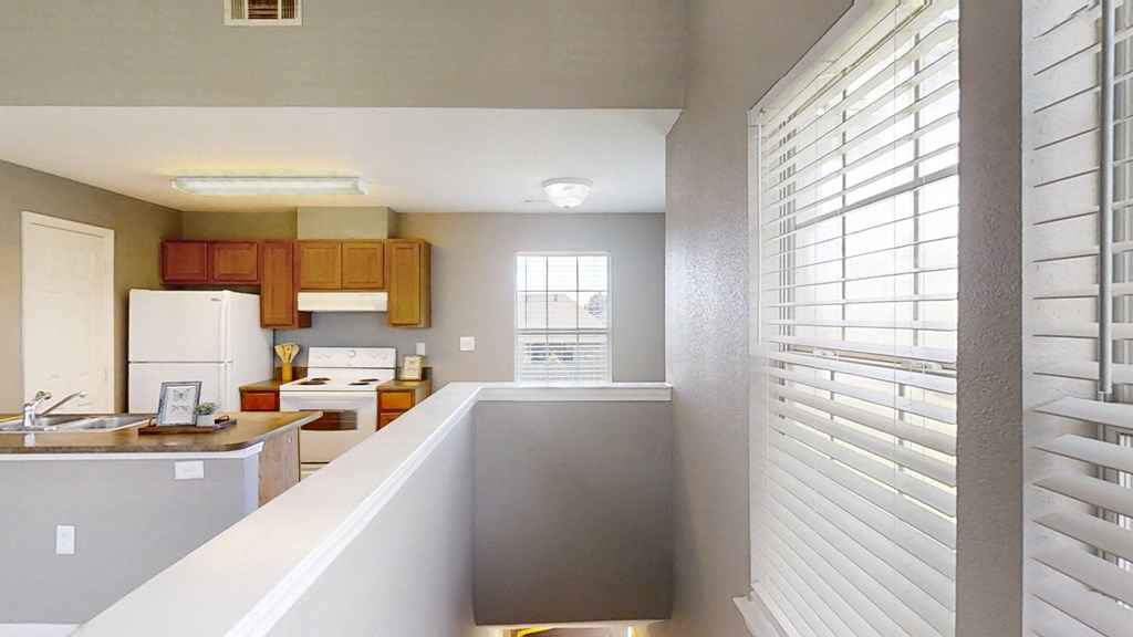 A view of a kitchen with a counter and a window