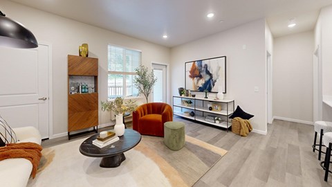 A living room with a brown coffee table and a brown and white striped couch.