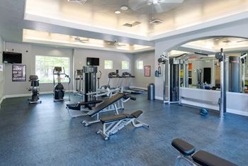 a gym with cardio equipment and weights in a building