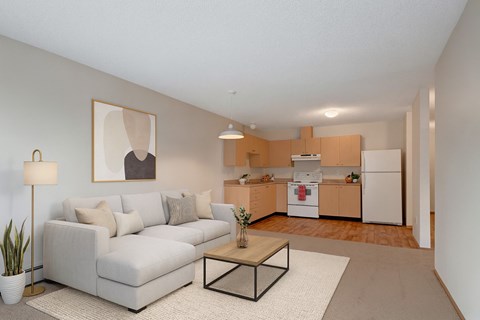 A living room with a white couch and a coffee table.