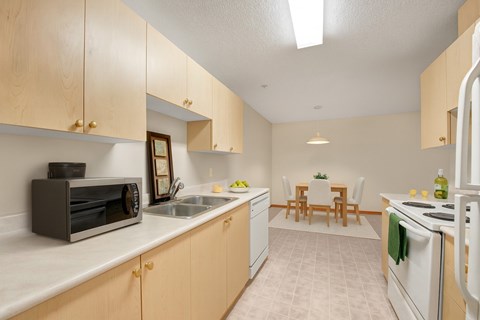 A kitchen with wooden cabinets and a white refrigerator.