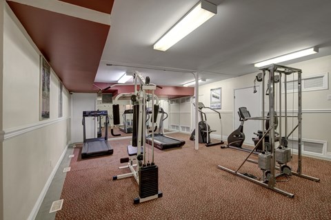 A well-equipped fitness center here at Park Place South featuring a variety of cardio machines, weight equipment, and open floor space, with bright overhead lighting and a functional layout that supports convenient workouts and everyday wellness routines.