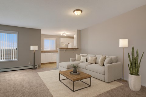 A bright, spacious living room here at The Pointe at Applewood with beige carpet, a light neutral sectional sofa, and a wooden coffee table. A large window brings in natural light, with an open kitchen and breakfast bar nearby.