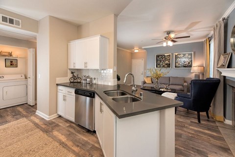 A kitchen with a sink and a stove.
