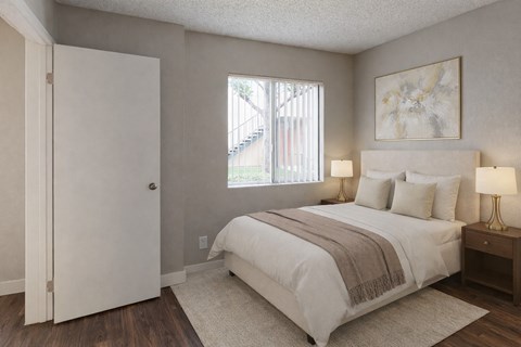 A bedroom with a large bed and a painting on the wall.