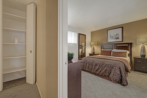 A bedroom with a large bed and a wardrobe.