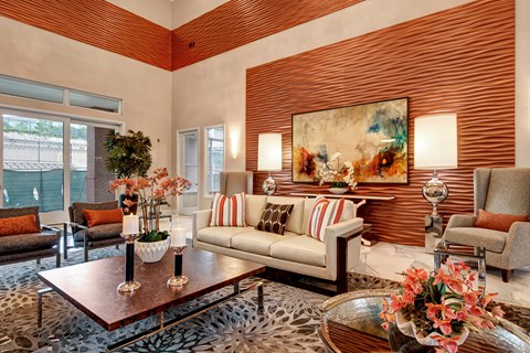 A living room with a leopard print rug and a painting on the wall.