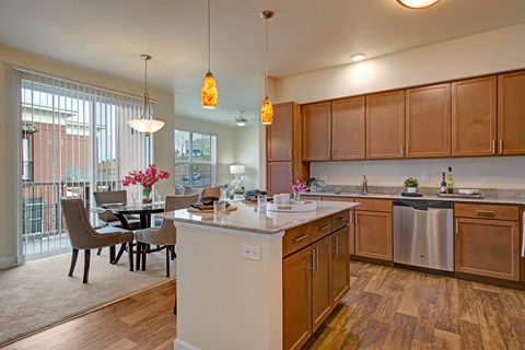 A kitchen with wooden cabinets and a white island.