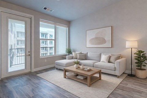 A living room with a white couch, a wooden coffee table, and a painting on the wall.