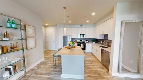 A kitchen with a white counter and a sink.