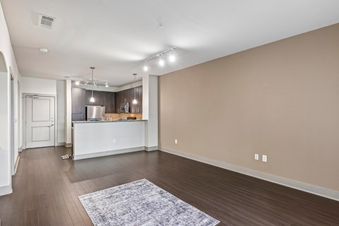 A spacious room with a kitchen island and bar area.