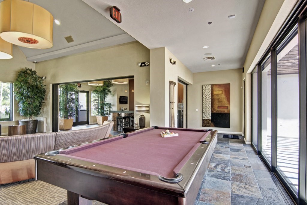 a pool table in the clubhouse at cobblestone apartments