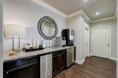 a kitchen with a counter top and a refrigerator and a microwave