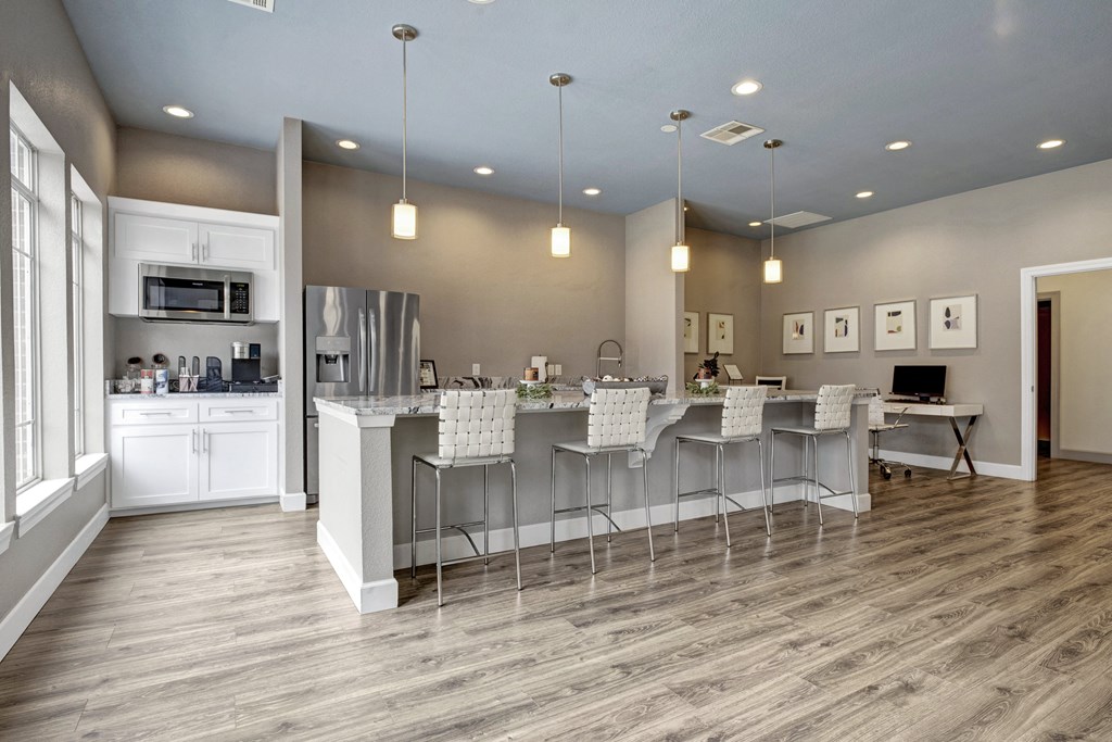 Resident kitchen and living room with a large island with bar stools Apartments for rent Springdale AR