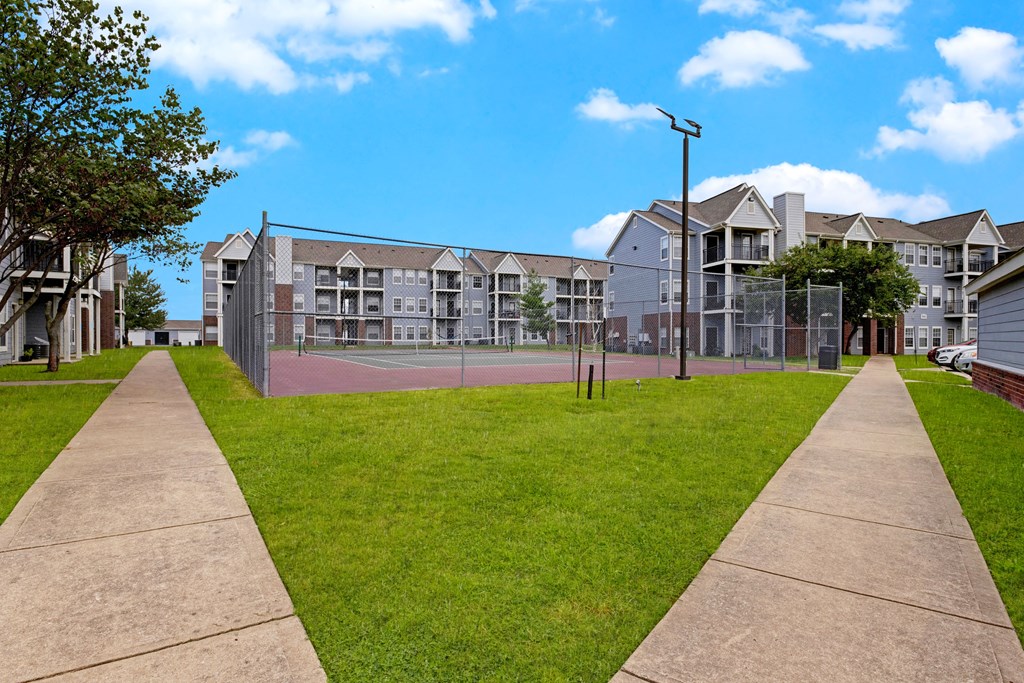 Large tennis court with apartments in the background Apartments for rent Springdale AR