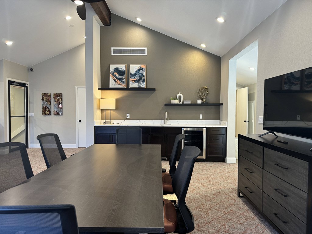 Lounge dining room with a table and a tv