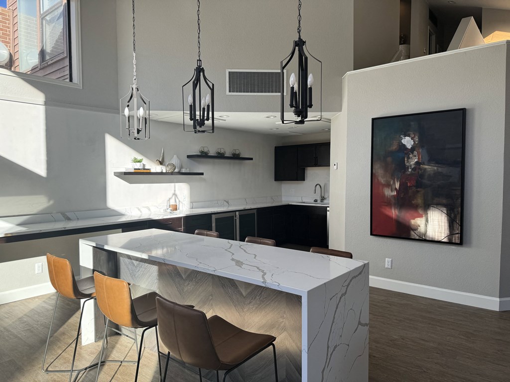 Lounge kitchen with a marble counter top and a dining area