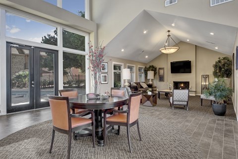 A dining room with a table set for six.