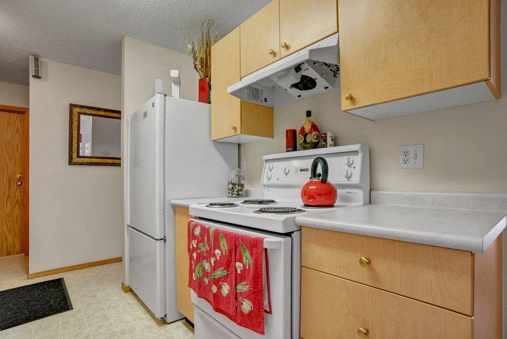 a kitchen with a white stove and a refrigerator