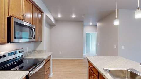 A kitchen with wooden cabinets and a stainless steel stove top oven.