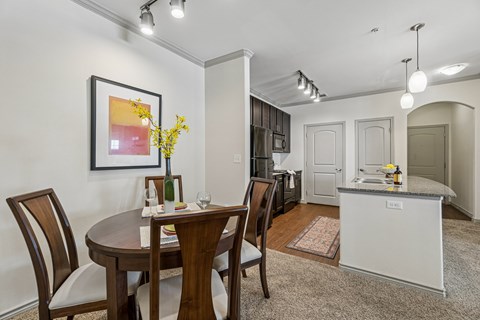 A dining room with a table set for two.