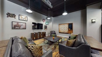 a living room filled with furniture and a flat screen tv