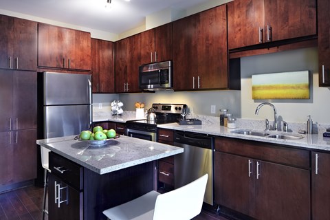 A kitchen with a table and chairs.