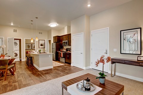 A modern kitchen with a dining table and chairs.