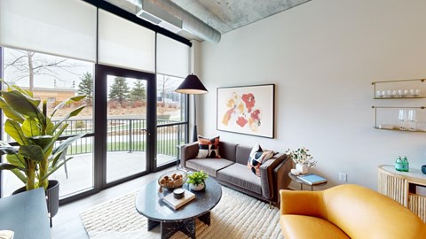 A living room with a grey couch, a yellow chair, a coffee table, and a painting on the wall.