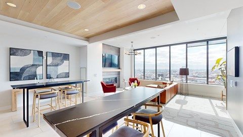 A modern dining room with a long table and chairs.