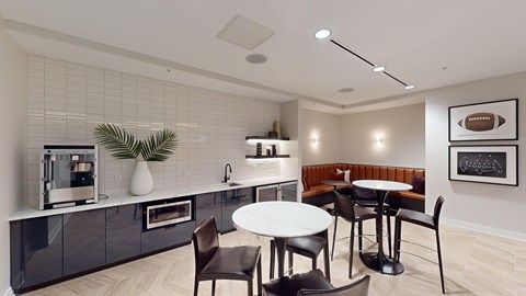 A modern kitchen with a dining table and chairs.