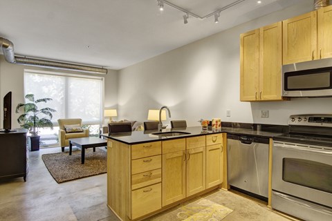 A kitchen with wooden cabinets and stainless steel appliances.