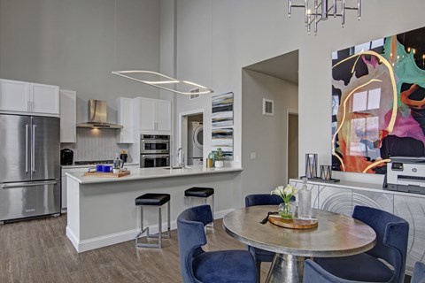 A modern kitchen with a dining table and chairs.