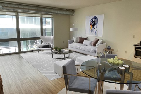 A modern living room with a glass table and a white sofa.