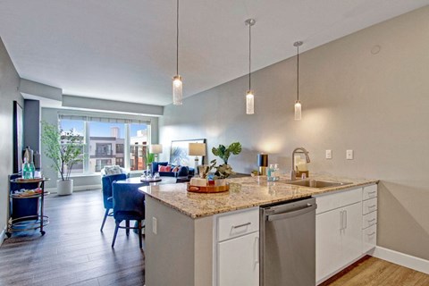 A kitchen with a dining table and chairs.