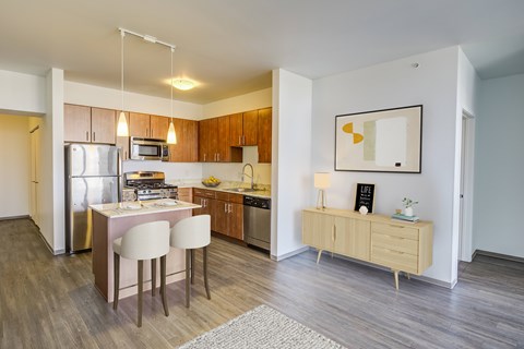 A modern kitchen with a dining table and chairs.