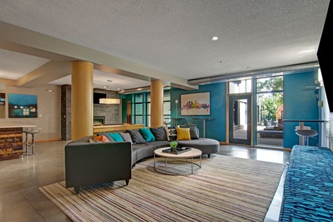 A living room with a grey sofa and a coffee table.