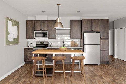 A kitchen with a table and chairs in front of a refrigerator.
