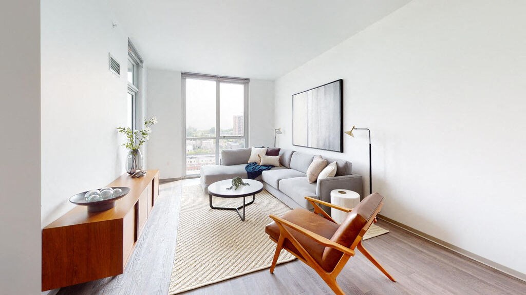 a living room with white walls and hardwood floors