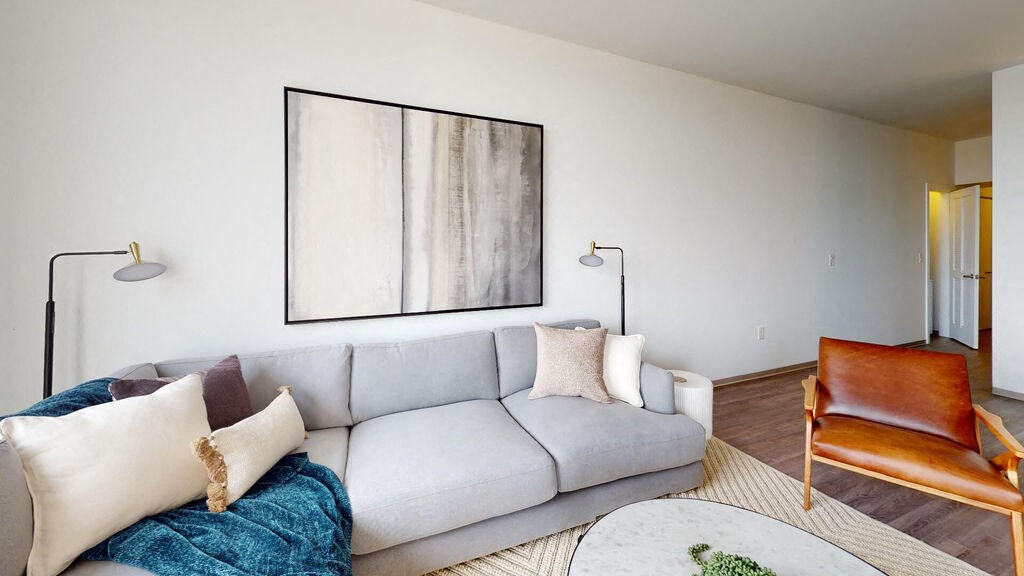 a living room with white walls and a gray couch