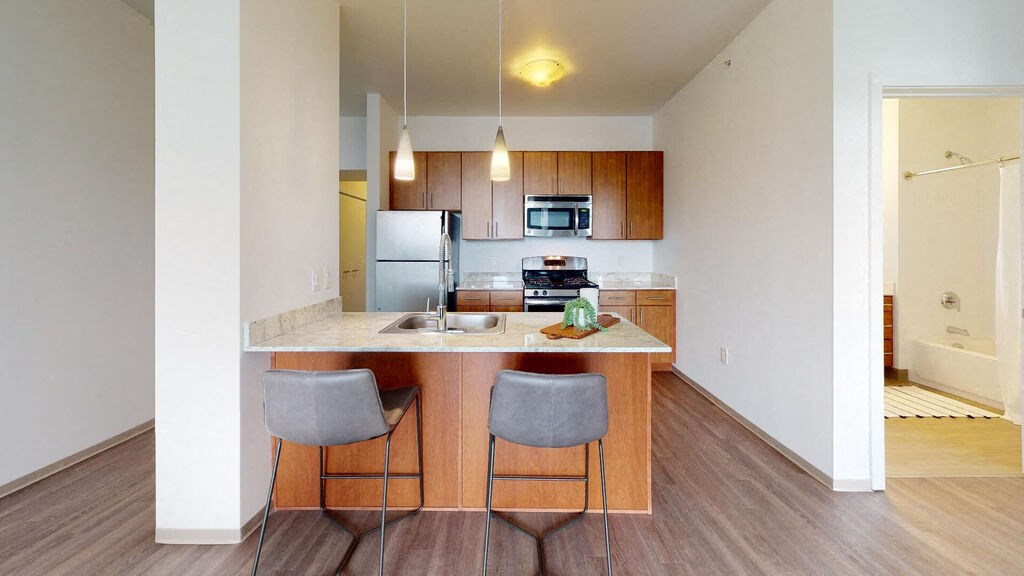 a kitchen with an island with two stools