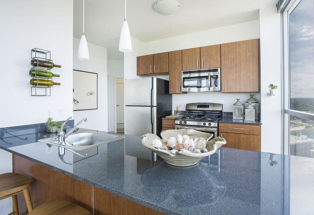 a kitchen with a sink stove and refrigerator